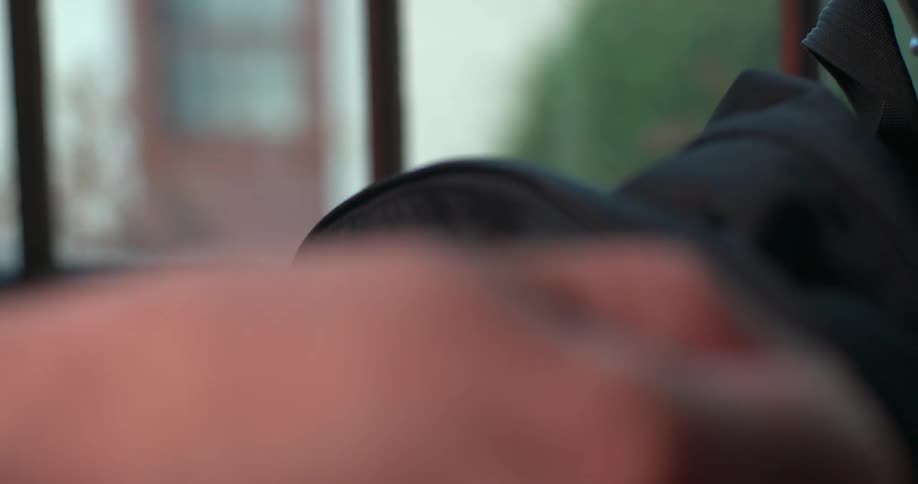 A person zips up a backpack