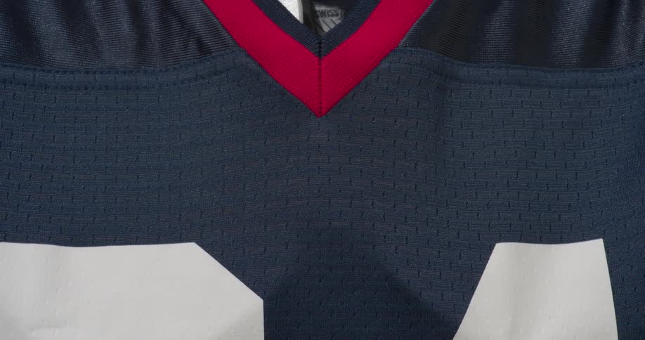 Person put a jersey on over padding