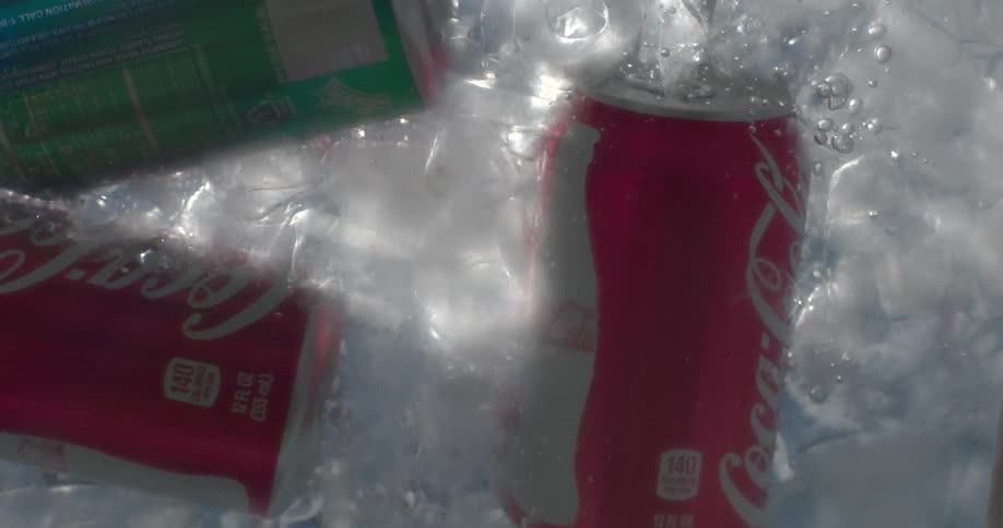 Cans of soda are dropped into ice