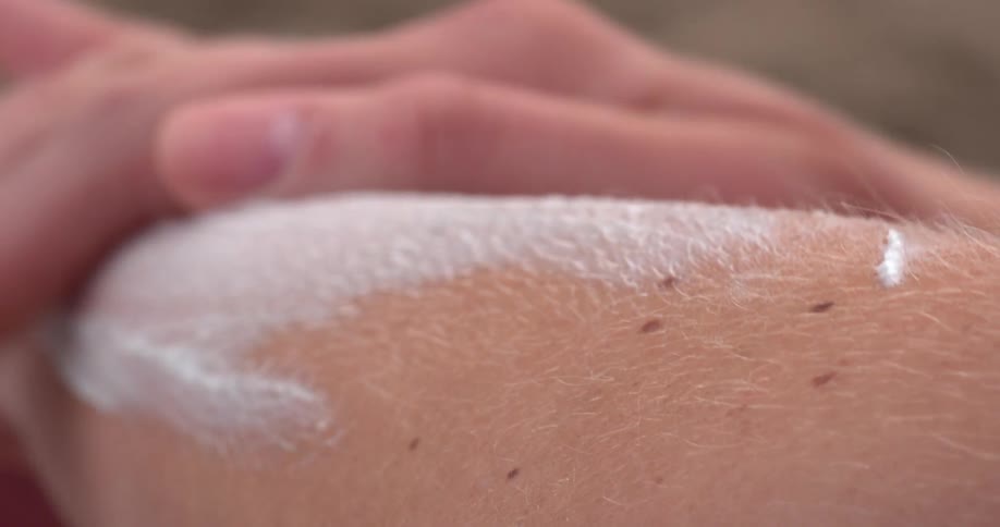 Lotion is rubbed on an arm