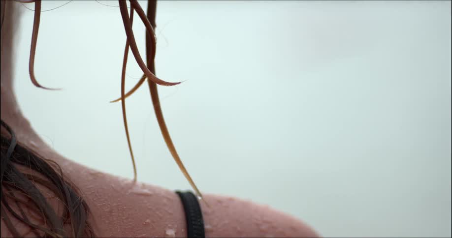 A woman's squeezes and wrings out her wet hair