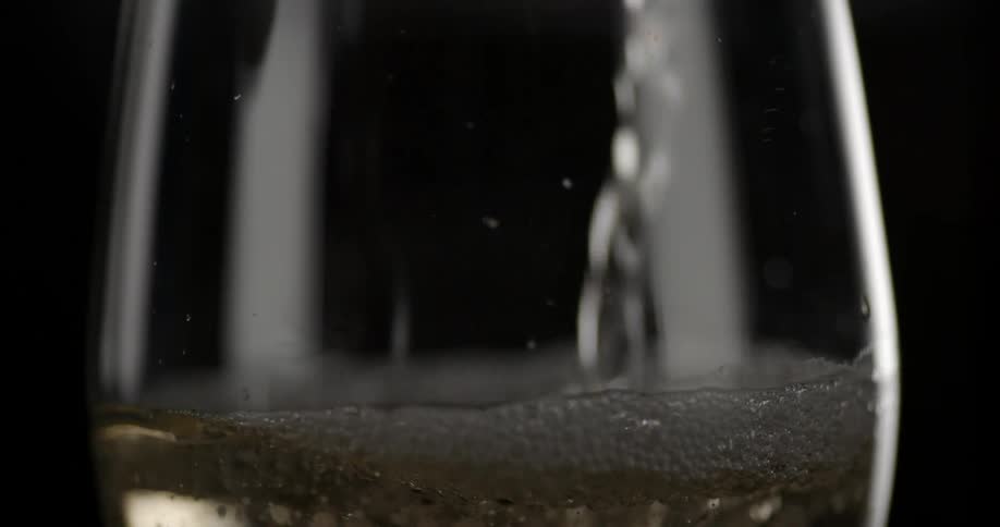 A drink is poured into a glass