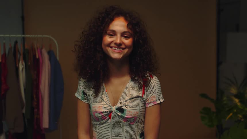 Young beautiful woman turns around and smiles