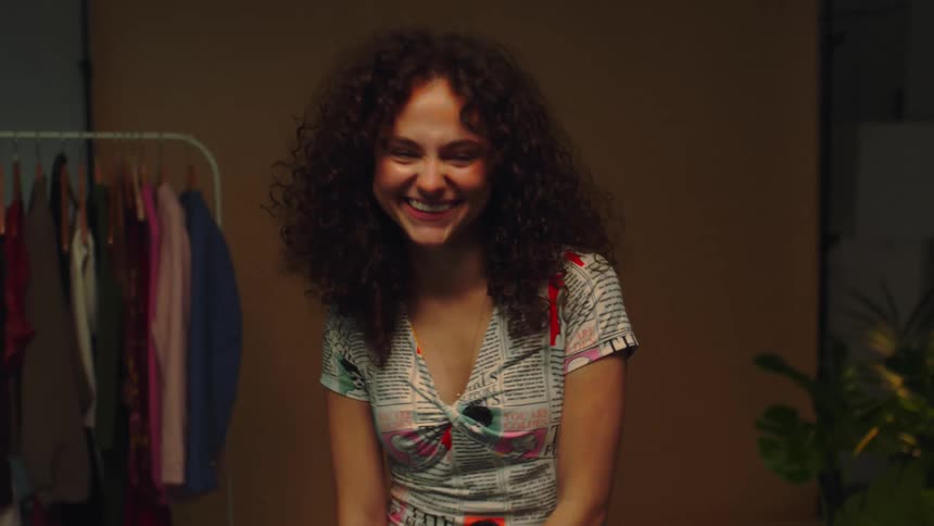 A young woman dancing with her hips and smiling