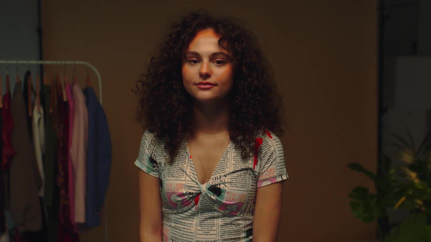 A girl smiling in a room