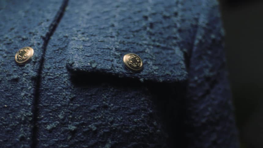 Close up of the buttons on a blue dress