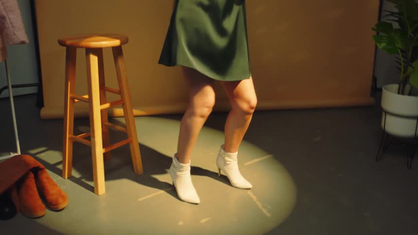 A girl dancing holding a disco ball in her hands
