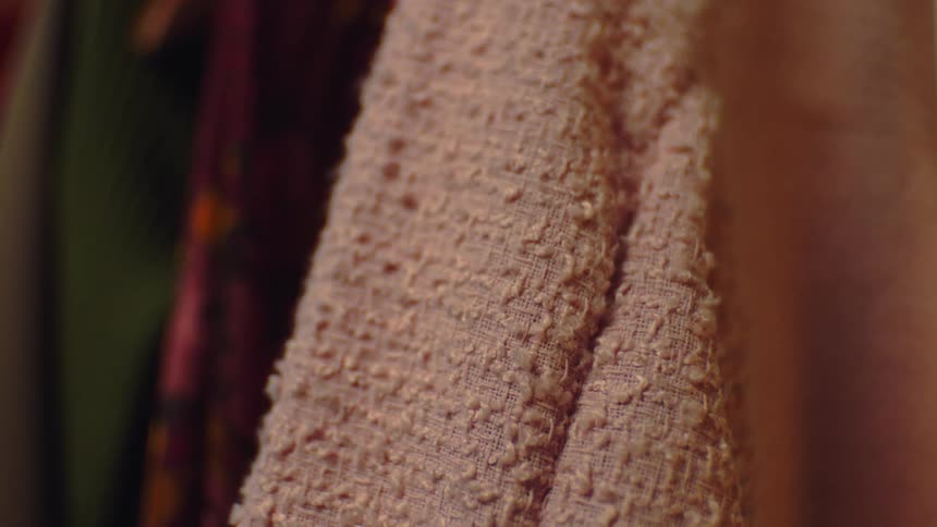 A peach colored piece of fabric is dangling while indoors