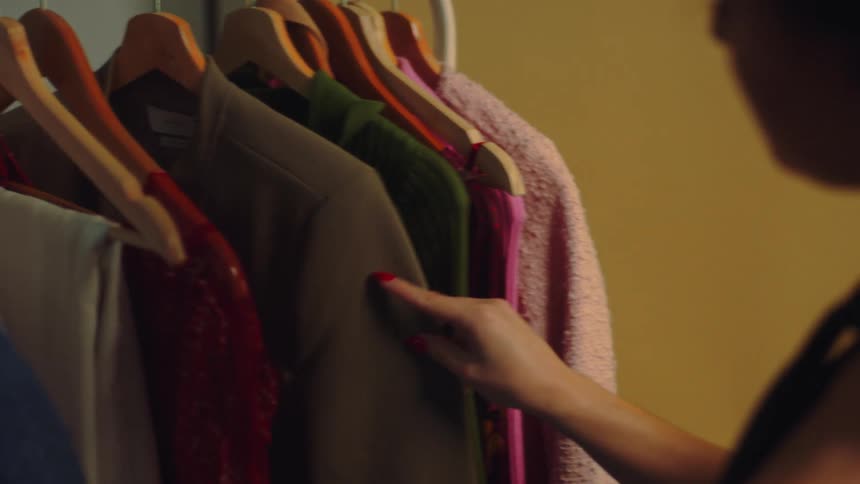 A woman is searching through her clothing