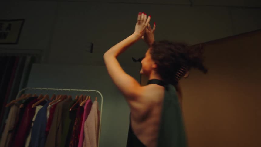 A female dancing indoor during a modeling shoot
