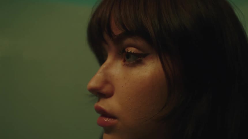 A young woman looking straight ahead