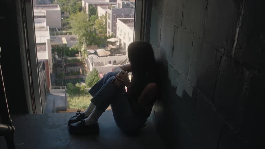 A girl observing the city from the top of a building
