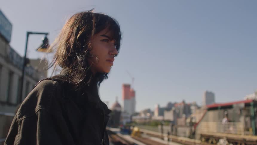 Girl waiting for a train in a station in the city