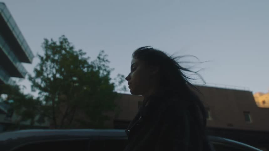 Woman walks on the city streets on a windy day