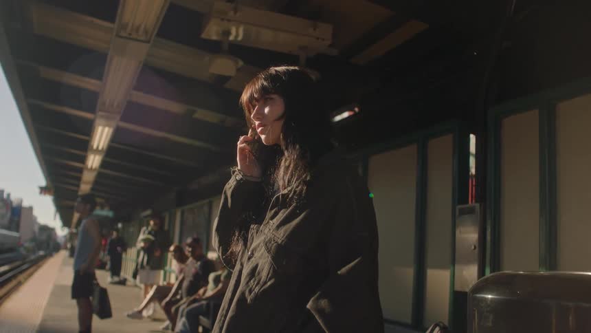 A woman waiting for transport at a train station