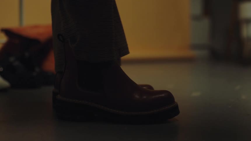 A person with brown boots on their feet
