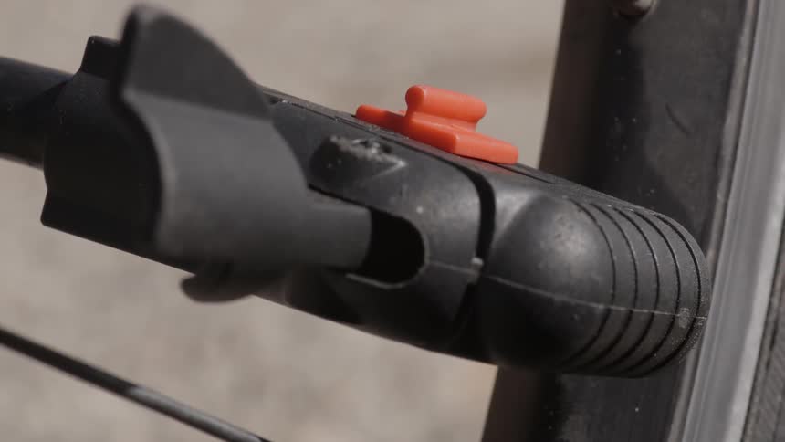 A person adjusts a bike pump