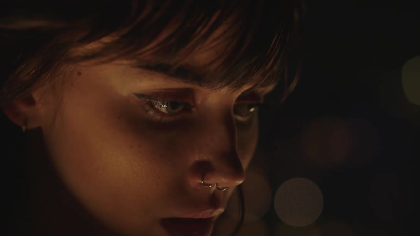 Closeup of a womans anxious face in the dark night