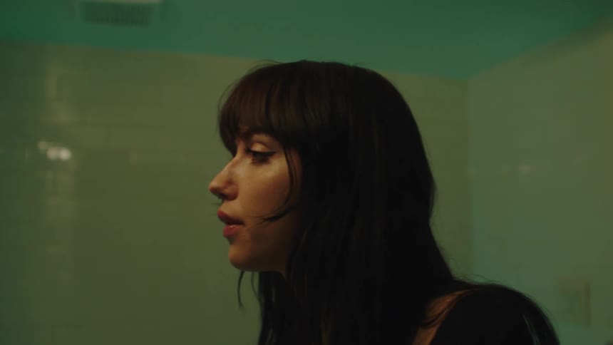 Portrait of a young woman entering the bathroom
