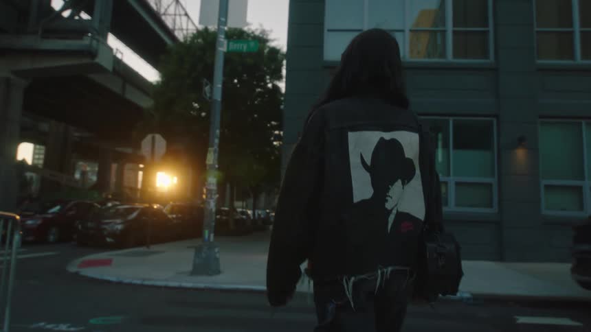 A woman crosses the street