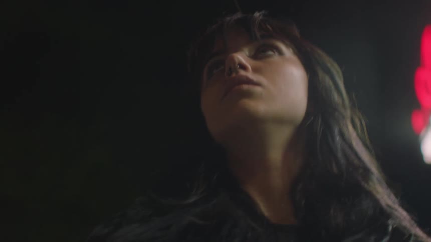 Young disoriented woman walks on the city at night