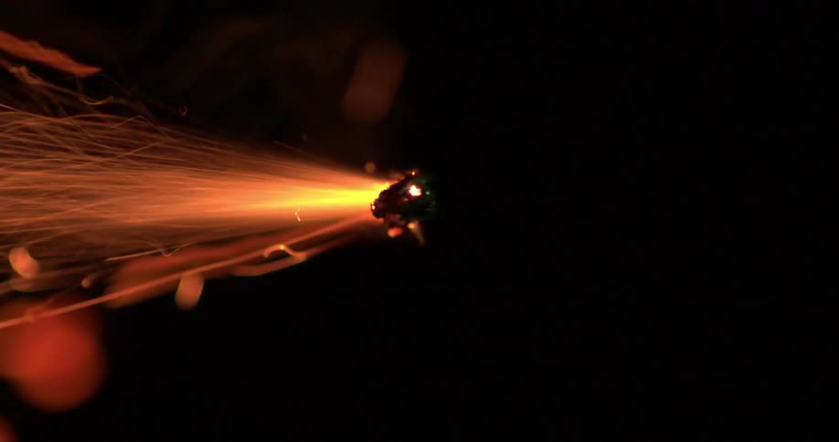 A fuse is lit in a dark room