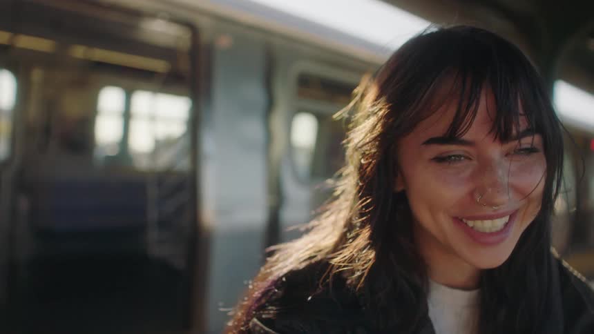 A woman is laughing outside the train