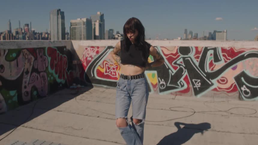 Young beautiful woman modeling on the roof of a building