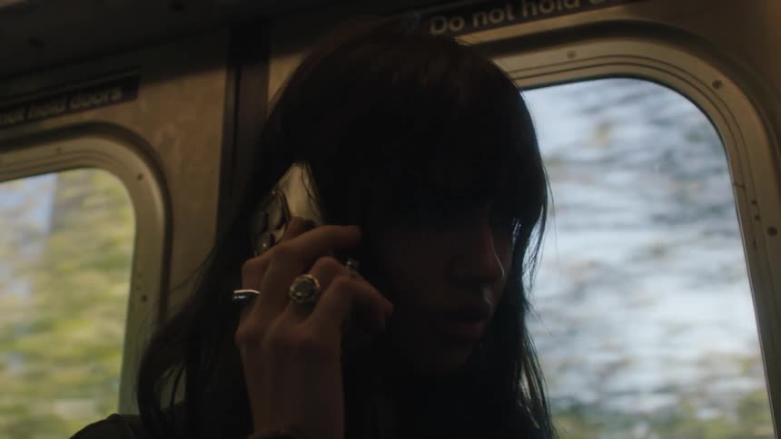 A woman talking on her cell phone on public transport