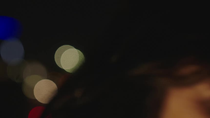 A lady with nose ring looking sad is outdoor at night