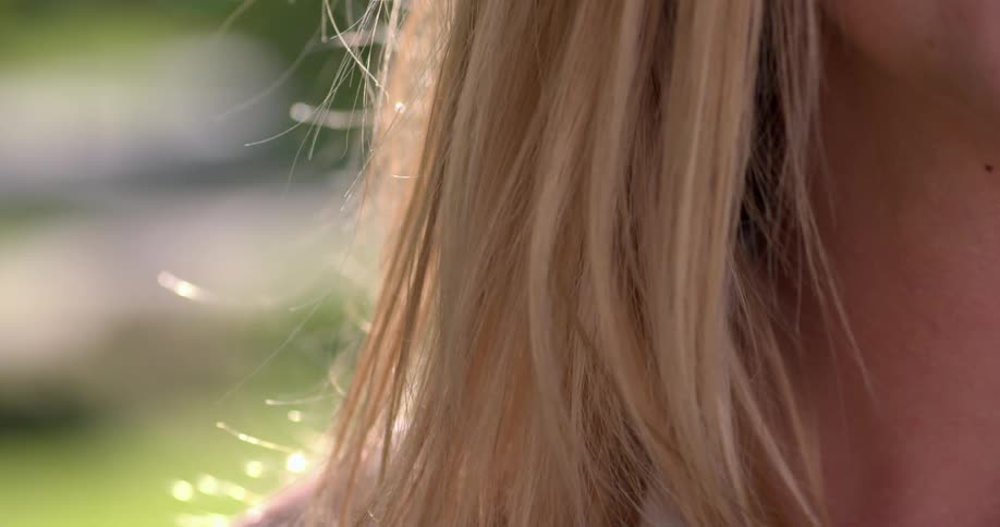 Sunlight shines on a woman's hair