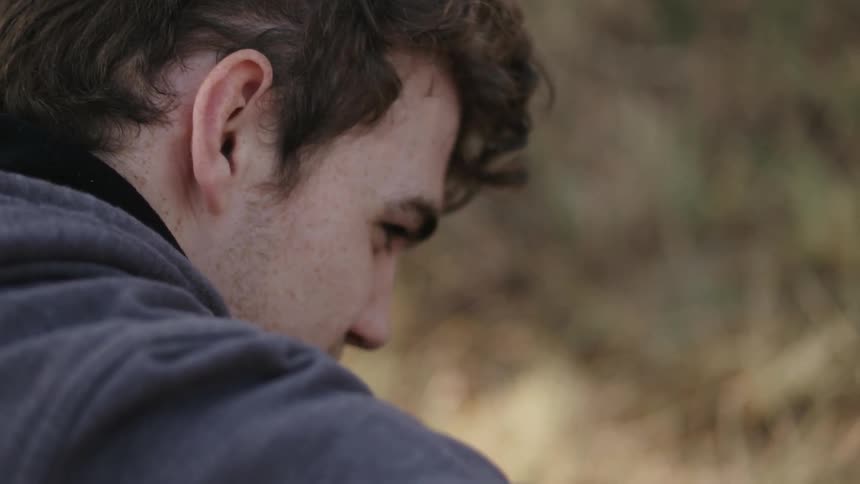 Close up of a man outside in a grassy area
