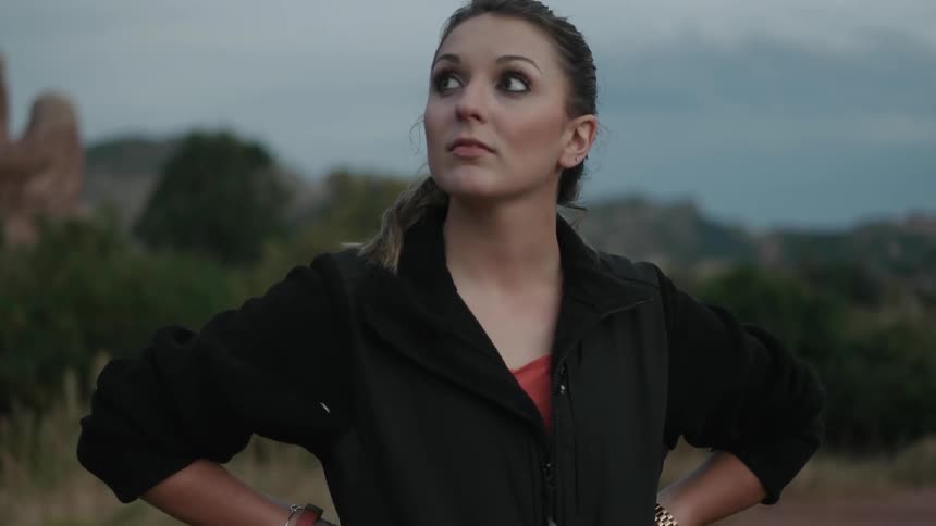 Woman standing and looking around in a wilderness area