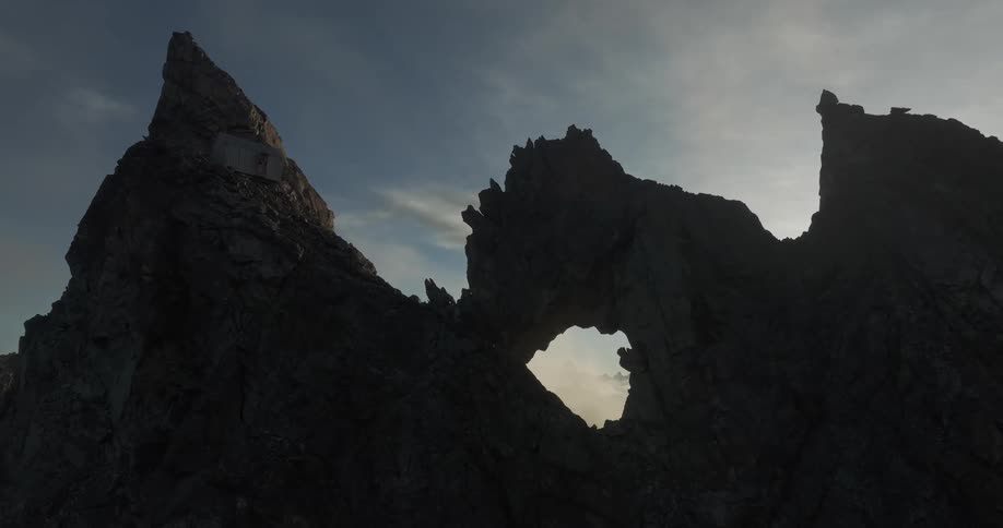 A hole in the middle of a tall rock formation