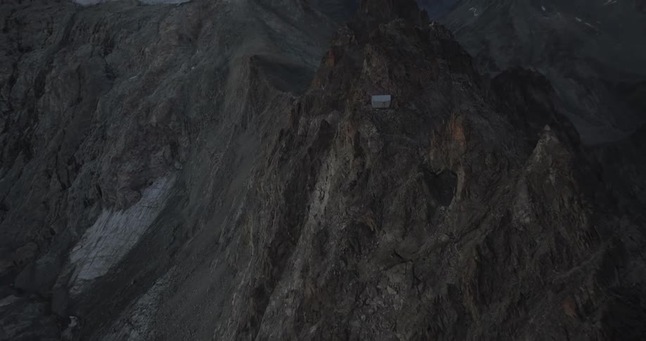 Small house amidst a mountain peak in the morning
