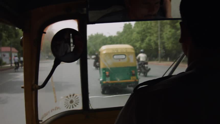 Vehicles drive down a large road
