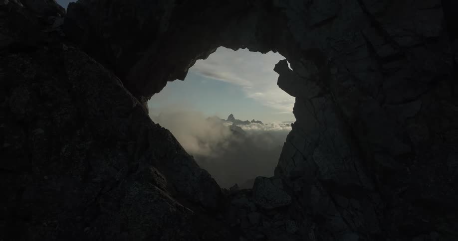 A hole in the middle of the rocky mountain at dawn