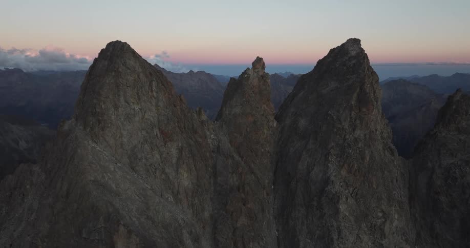 An aerial view captures the rugged beauty of a mountainous area where peaks and valleys form a breathtaking and untamed landscape