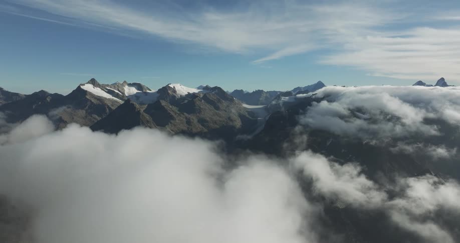Mountain peaks on horizon with cloud coverage during the day