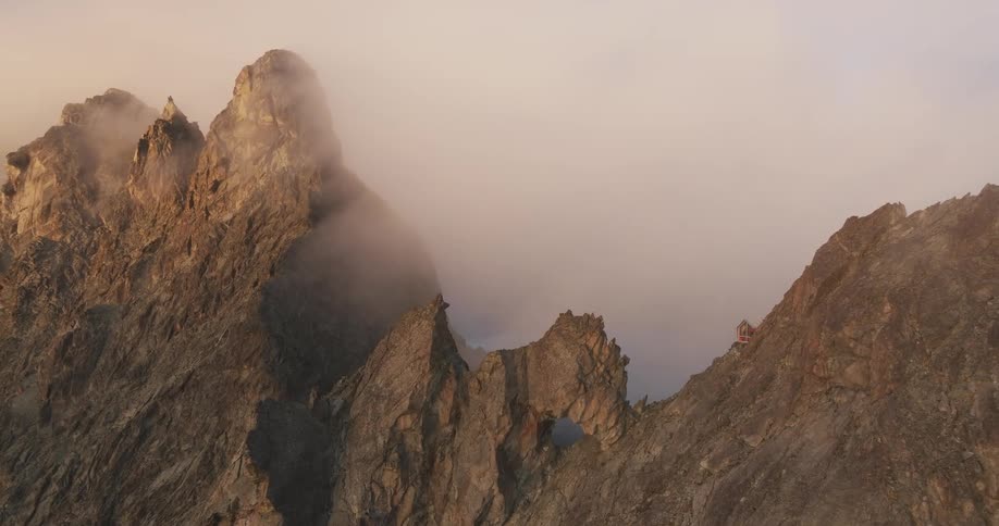 View of mountain peaks above the clouds