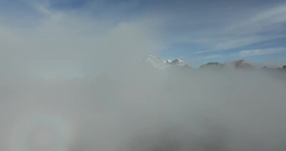 The clouds sit on the peaks of the mountains