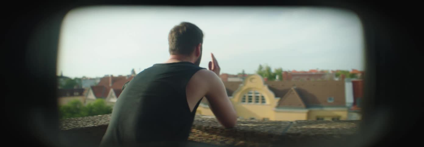 Man with his back turned placing hands on his head with a sign of concern