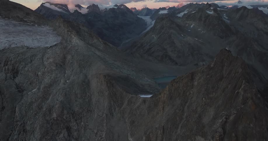 Aerial of a lake on top of a mountain at sunset