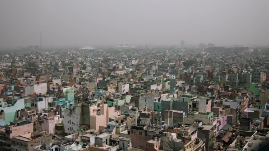Birds fly over this city on a cloudy day