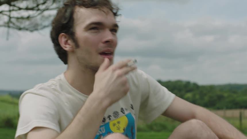 A man is smoking a cigarette outdoors