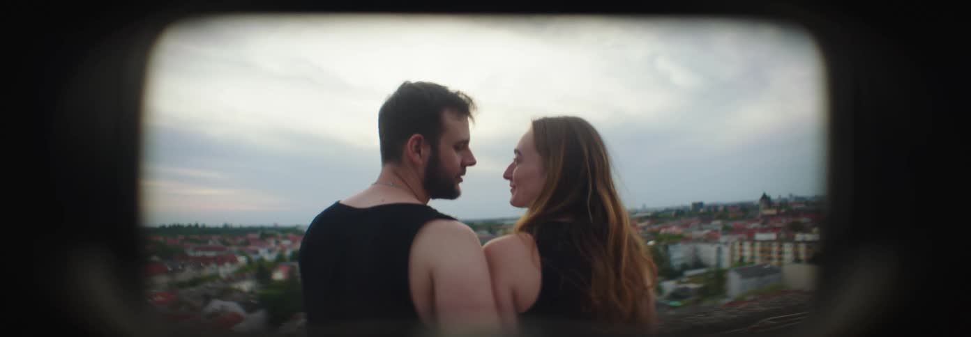 Couple looking at each other in front of the city