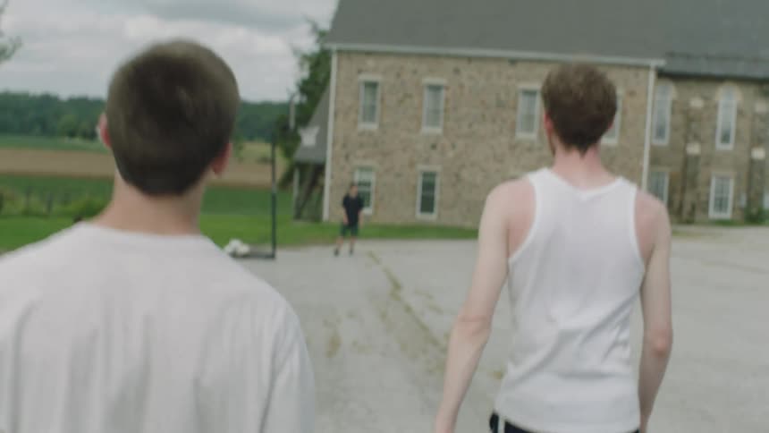 Friends playing basketball on an outdoor court