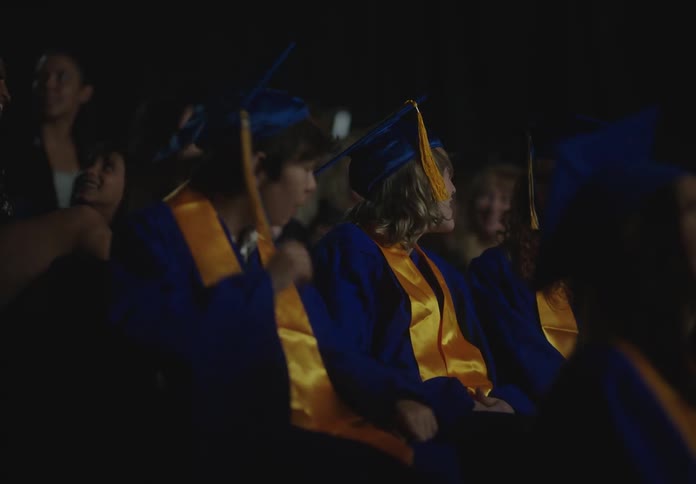 Students sitting in an auditorium in graduation day