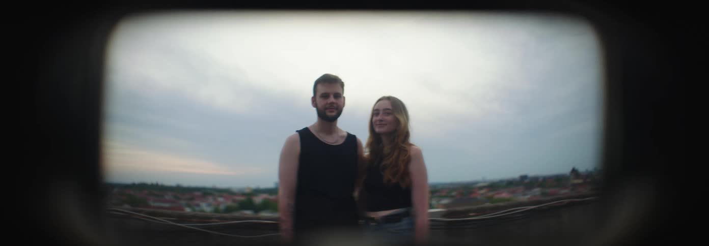 Couples smiling to the camera on the roof top