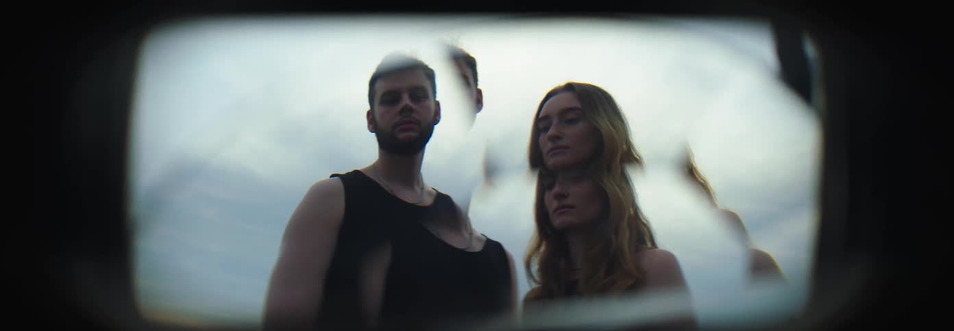 Two people stand together through the lens